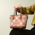 luxury-zhuang-brocade-embroidered-leather-zipper-crossbody-bag-model-sitting-knee-handheld