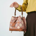 model-arm-carry-brocade-bucket-bag-front