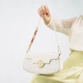 model-holding-octagonal-brocade-bag-seated