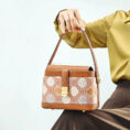 model-seated-brocade-bag-on-knees