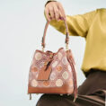 model-seated-brocade-bucket-bag-on-knees