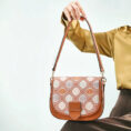 model-seated-holding-brocade-bag-on-lap
