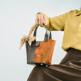 model-seated-plum-blossom-handbag-on-knees