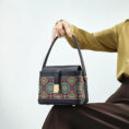 model-seated-song-brocade-bag-on-knees