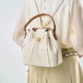wanj-pattern-embroidered-leather-convertible-backpack-tote-model-wearing-backpack-from-behind