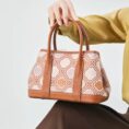 zhuang-brocade-chrysanthemum-crossbody-bag-model-sitting-knee