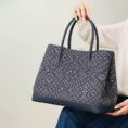 zhuang-brocade-embroidered-leather-shoulder-bag-model-sitting-knee-blue-dress