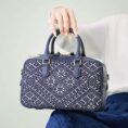 zhuang-brocade-flying-swallow-embroidered-leather-crossbody-bag-model-blue-dress-sitting-knee